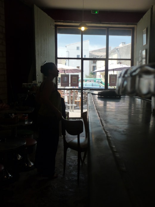 Photograph of the artist's silhouette while hanging her work in the Petit Troc by Kai Lewis copyright 2015